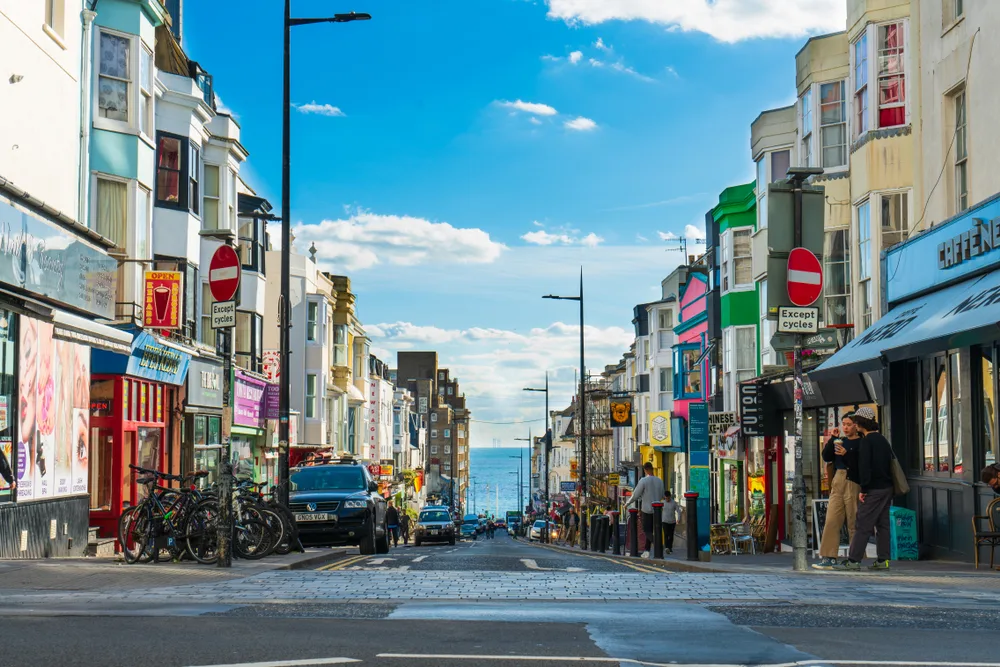 Town in Brighton, one of the best places to visit in the United Kingdom, pictured looking through buildings on either side of the road toward the ocean