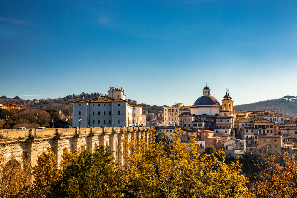 View of Ariccia, a walled town that houses Castelli Romani, pictured on a clear day for a roundup of day trips from Rome