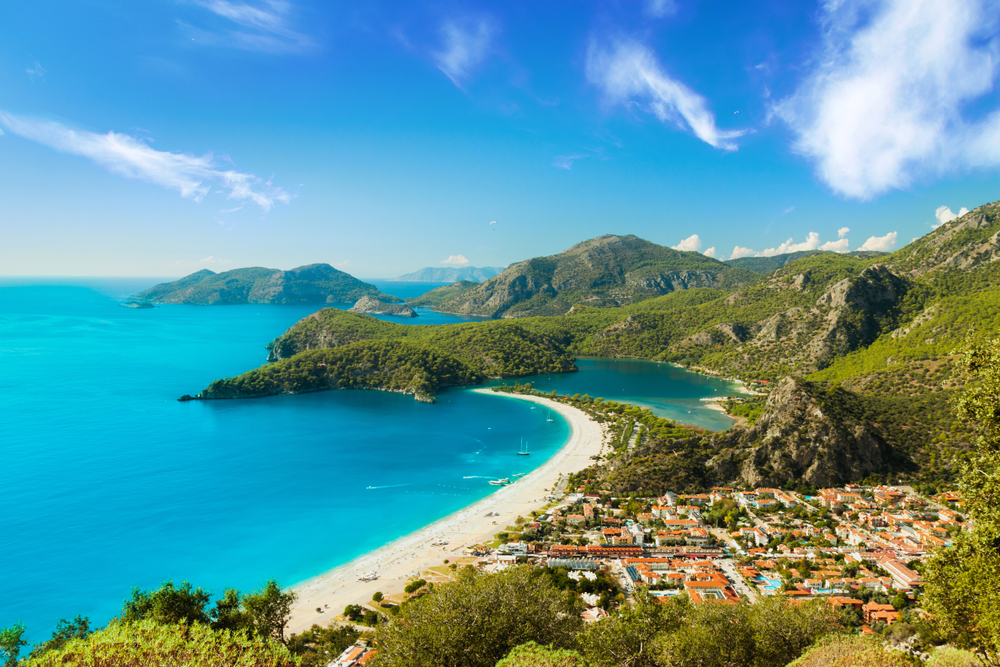 Aerial view of Oludeniz, one of the top places to visit in Turkey, pictured with white sand beaches stretching across the coastline