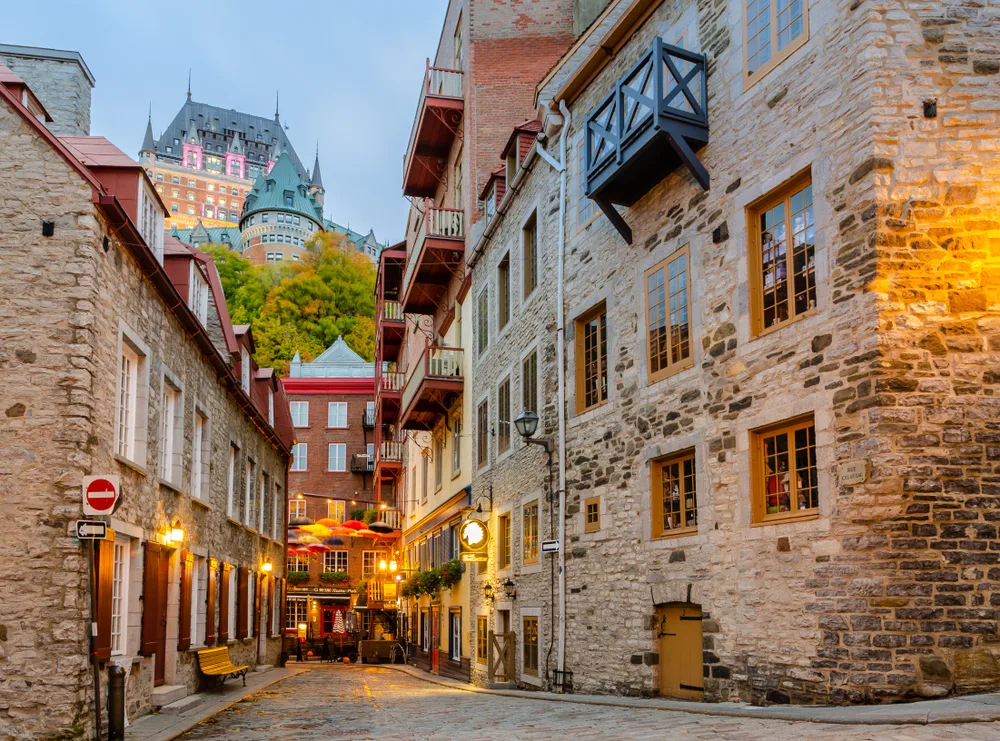 Gorgeous historical-style alleyway between large buildings pictured during the best time to visit Quebec City
