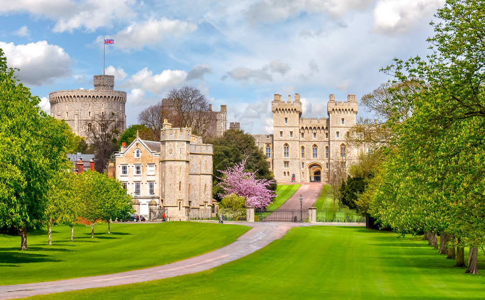 Carefully manicured lawn of Windsor, one of the best day trips from London, as seen from the end of the lawn looking toward the castle