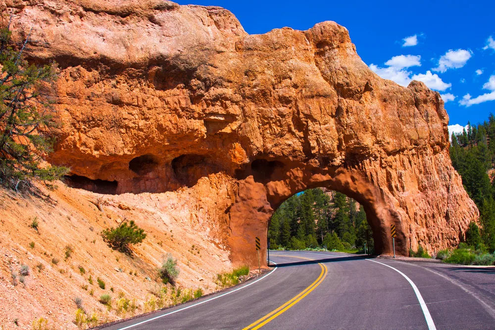 Road through a rock tunnel in Bryce Canyon on a semi-cloudy day