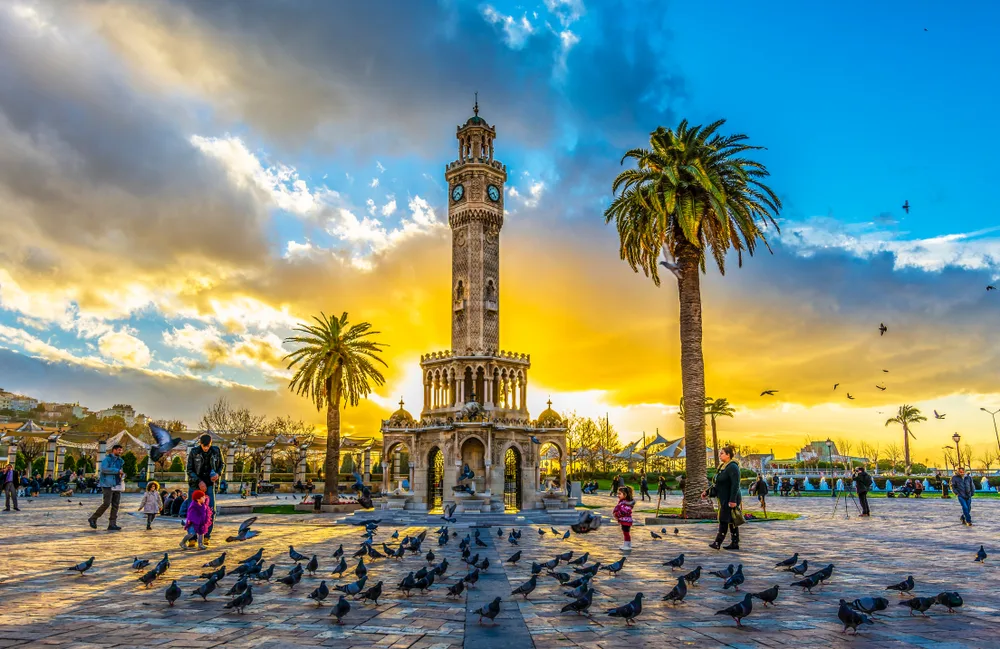 Very neat dusk view of the Konak Square and clock tower with palm trees in the background in Izmir, one of the best places to visit in Turkey