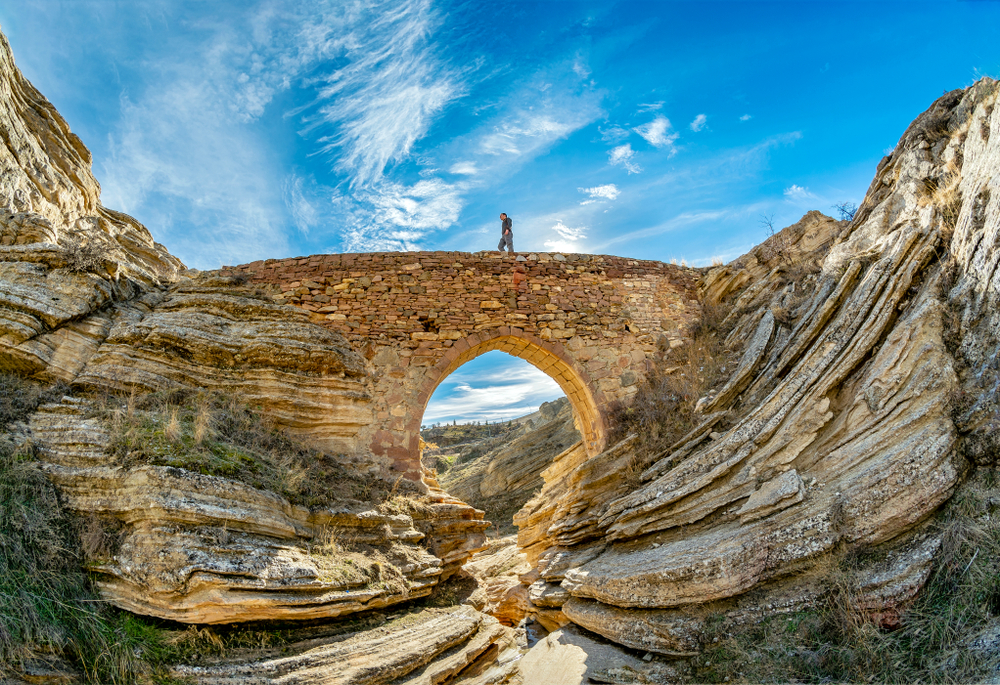 Devil's Bridge in Konya pictured with a guy walking on it for a piece on the best places to visit in Turkey
