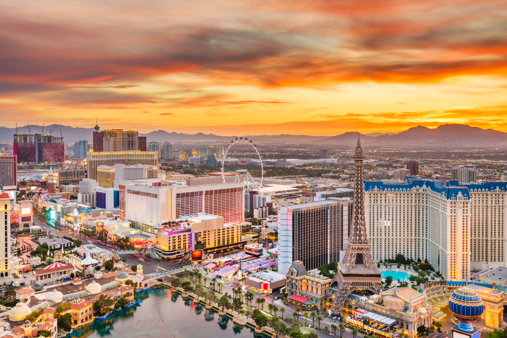 Aerial view of Las Vegas, one of the best places to visit in the US, pictured with the strip below a gorgeous orange dusk sky