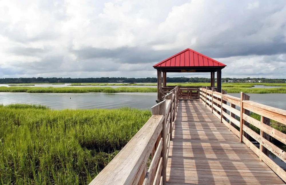 Image of an empty pier overlooking a marsh, as seen during the least busy time to visit Hilton Head