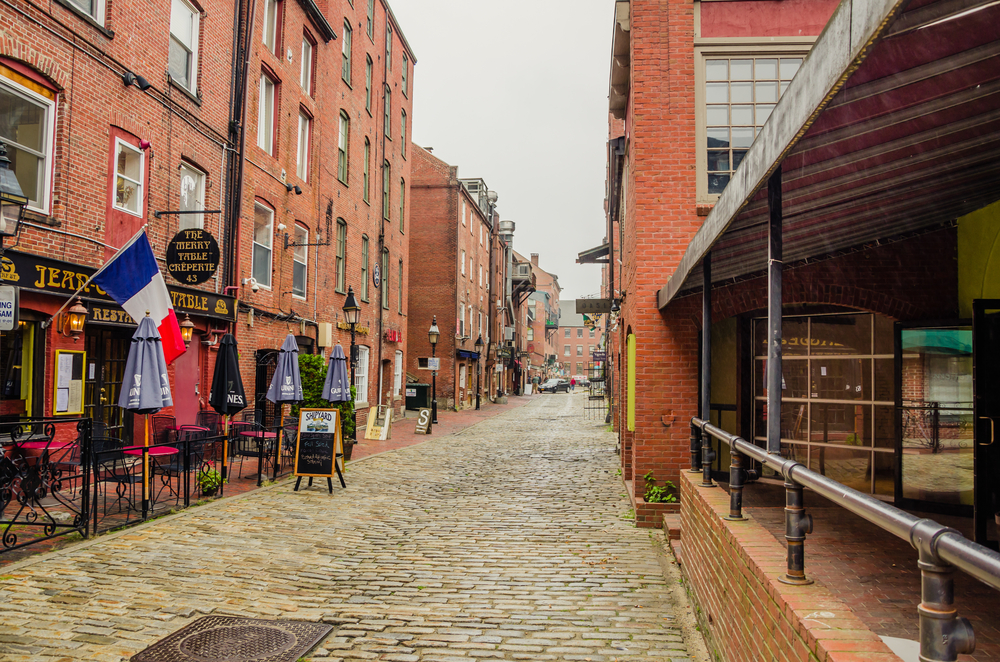 Long brick walkway leading down the road to the downtown area pictured during the best time to visit Portland in Maine