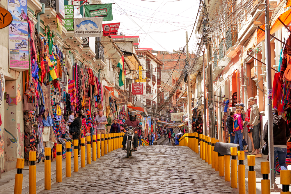Colorful marketplace with a stone road down the middle as a piece on the best places to visit in South America, La Paz