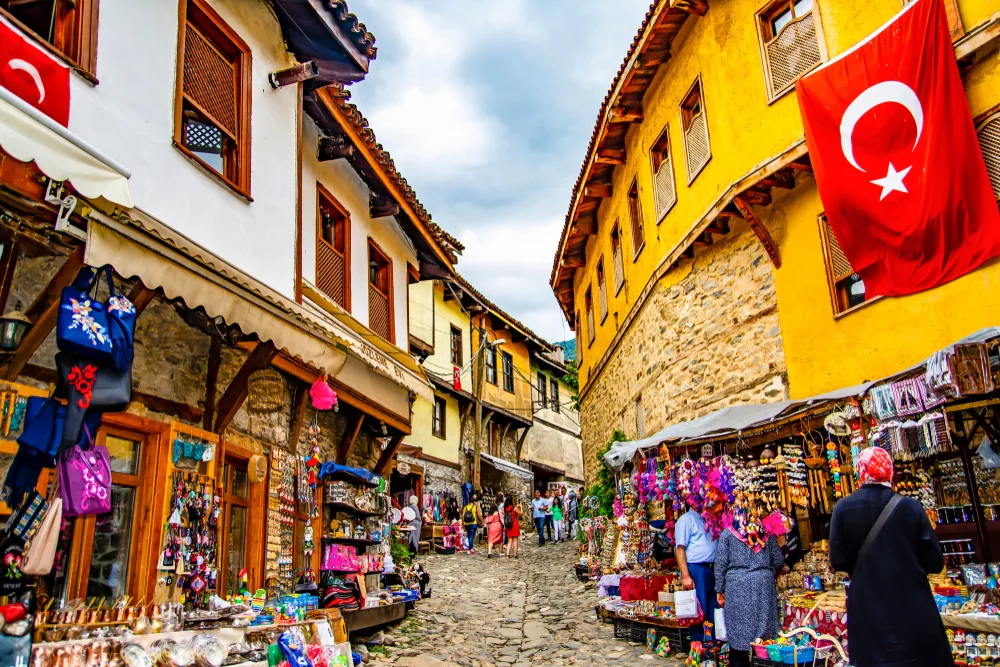Yellow and beige buildings on either side of the stone walking path in Bursa, one of the best places to visit in Turkey