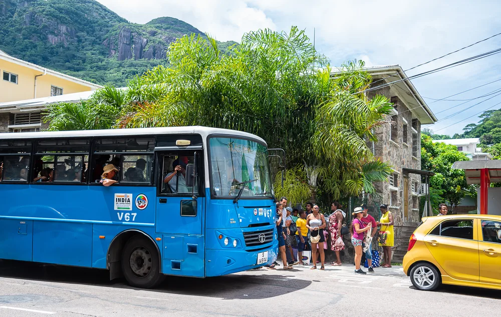 Victoria Seychelles pictured with a blue bus outside of the old-time colonial buildings during the best time to visit Seychelles