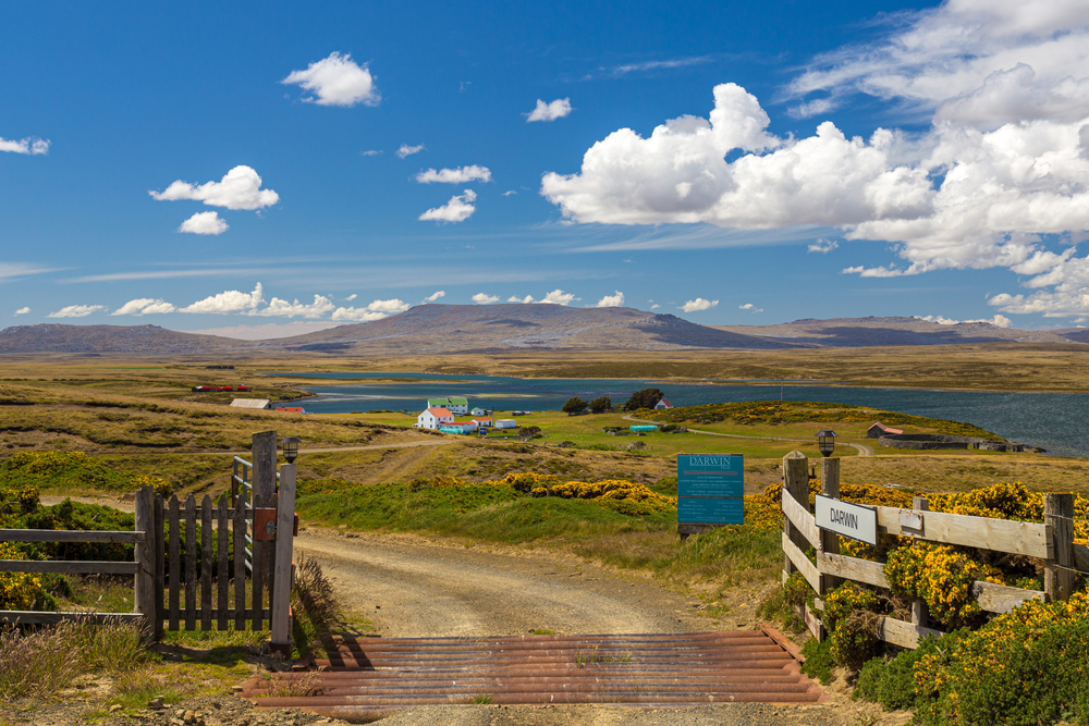 Wooden gates open to a road leading to the town of Darwin in the Falkland Islands