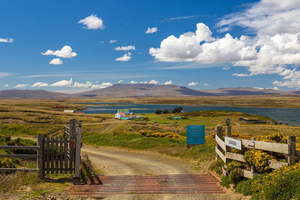 Wooden gates open to a road leading to the town of Darwin in the Falkland Islands