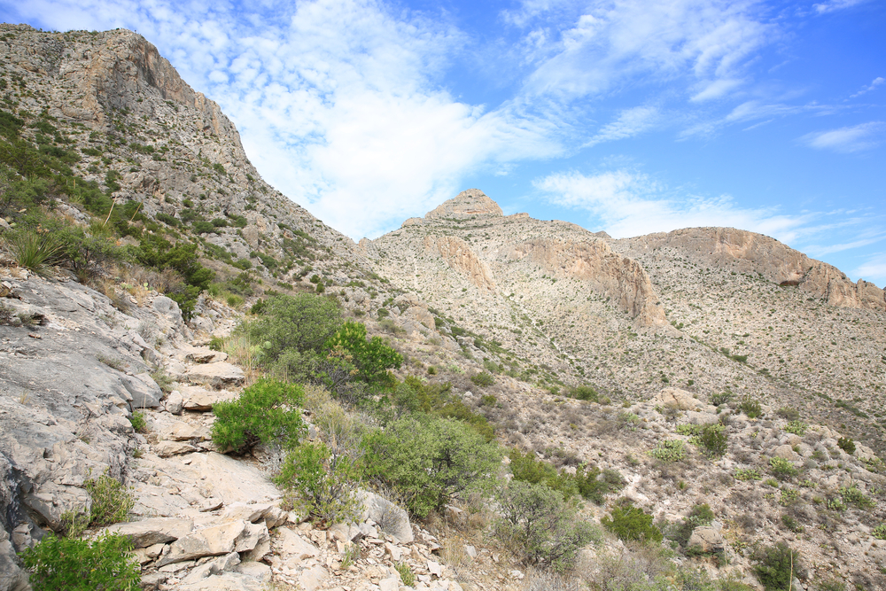 Slaughter Canyon pictured with a stone path leading up a steep hill in the desert