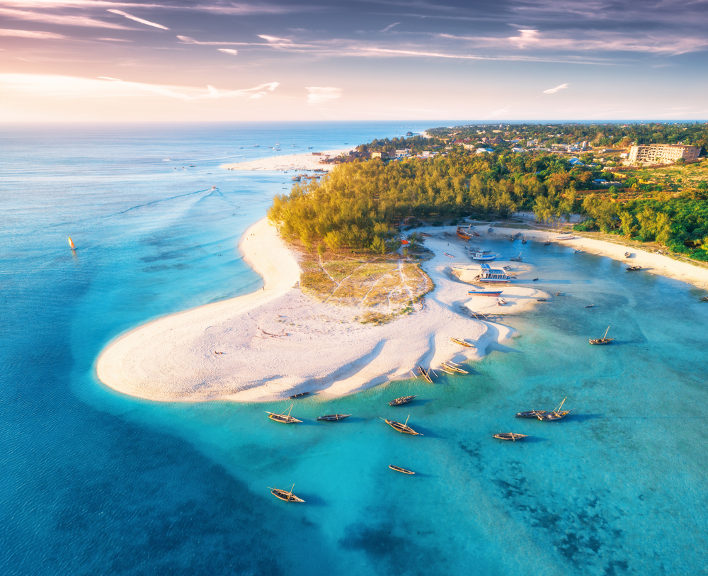 Aerial view of a resort, the beach, and a coastline taken during the best time to visit Zanzibar