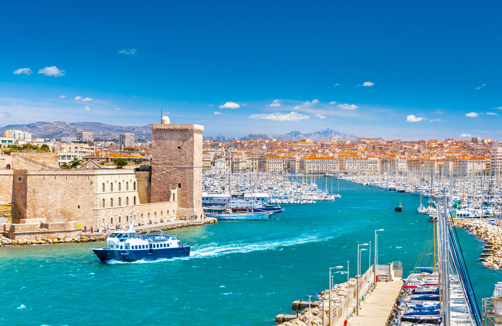 Stunning aerial view of Marseille, one of the best places to visit in France, pictured with boats driving along the river