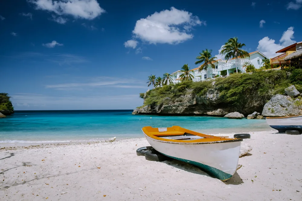 Wooden boat on the beach by the harbor at Curacao during the best overall time to visit