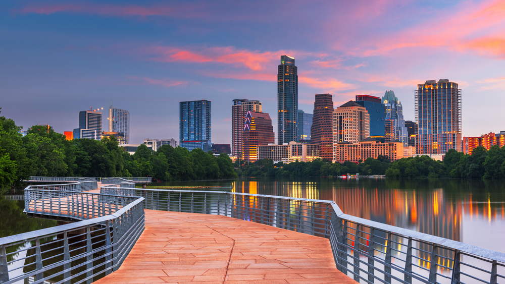 Amazing view of downtown Austin Texas, one of the best places to visit in the Winter in the USA, as seen in the Winter from the POV of someone standing on the lake bridge