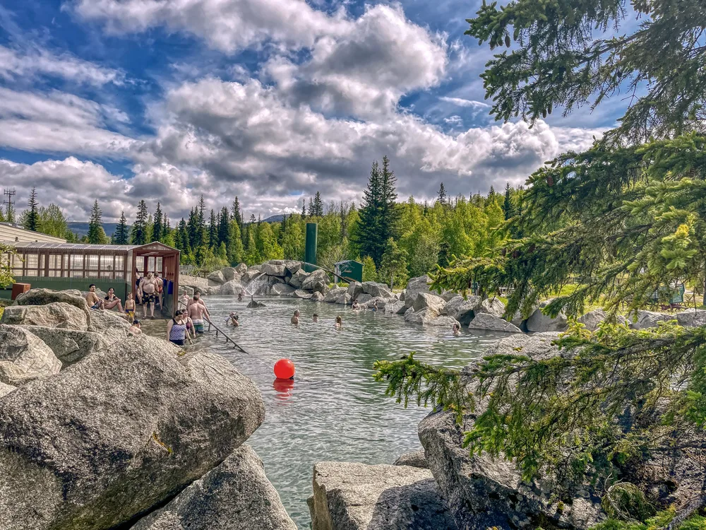 Multiple people relaxing in the Chena Hot Springs in Fairbanks, taken during the best time to visit