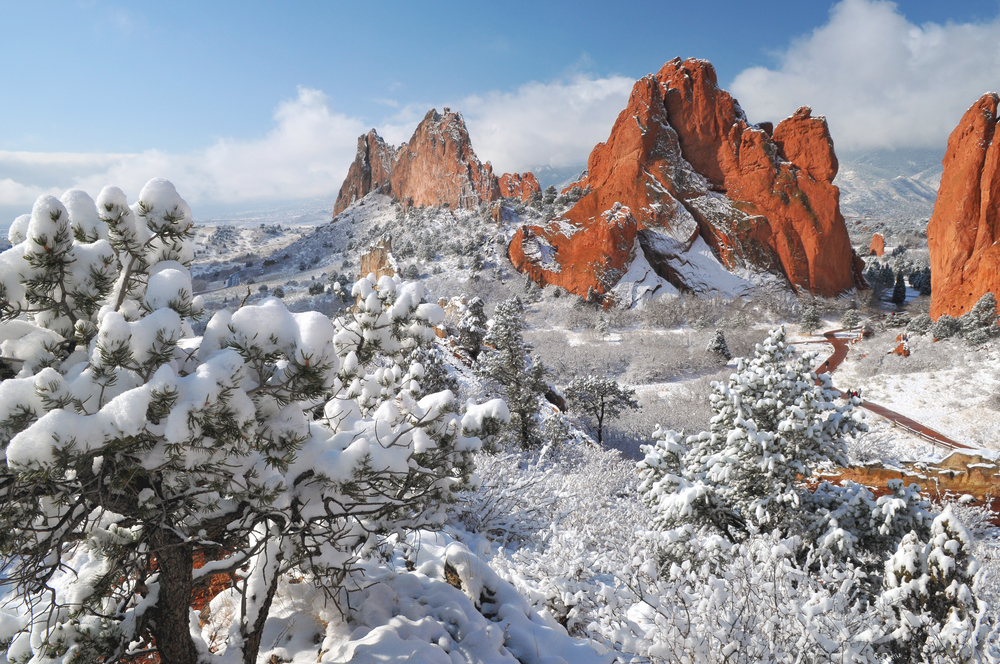 Garden of the Gods pictured with snow on the ground with clear skies above the mountains during the winter, the least busy time to visit Colorado Springs