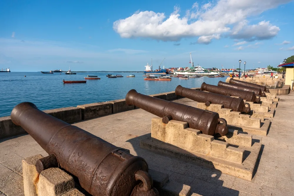 Cannons facing the ocean pictured during the best time to visit Zanzibar