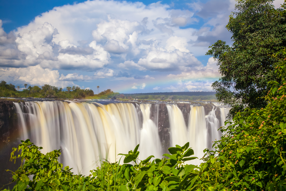 Clouds above the waterfall pictured during the cheapest time to visit Victoria Falls
