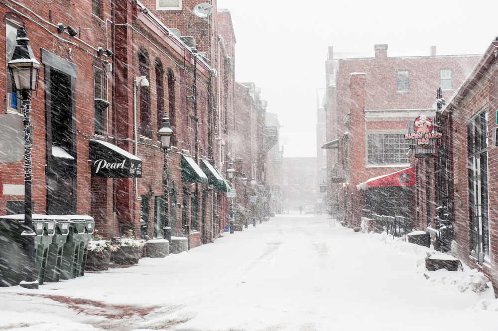 Long road between brick buildings pictured during the winter, the overall worst time to visit Portland Maine