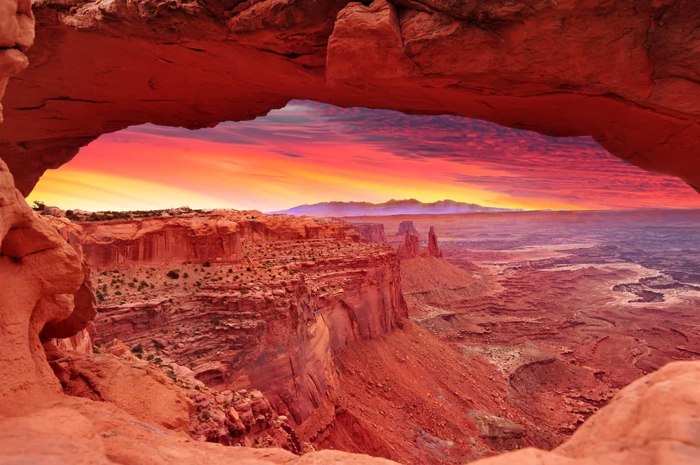 Sunrise in the Mesa Arch pictured for a piece on the best places to visit in the US