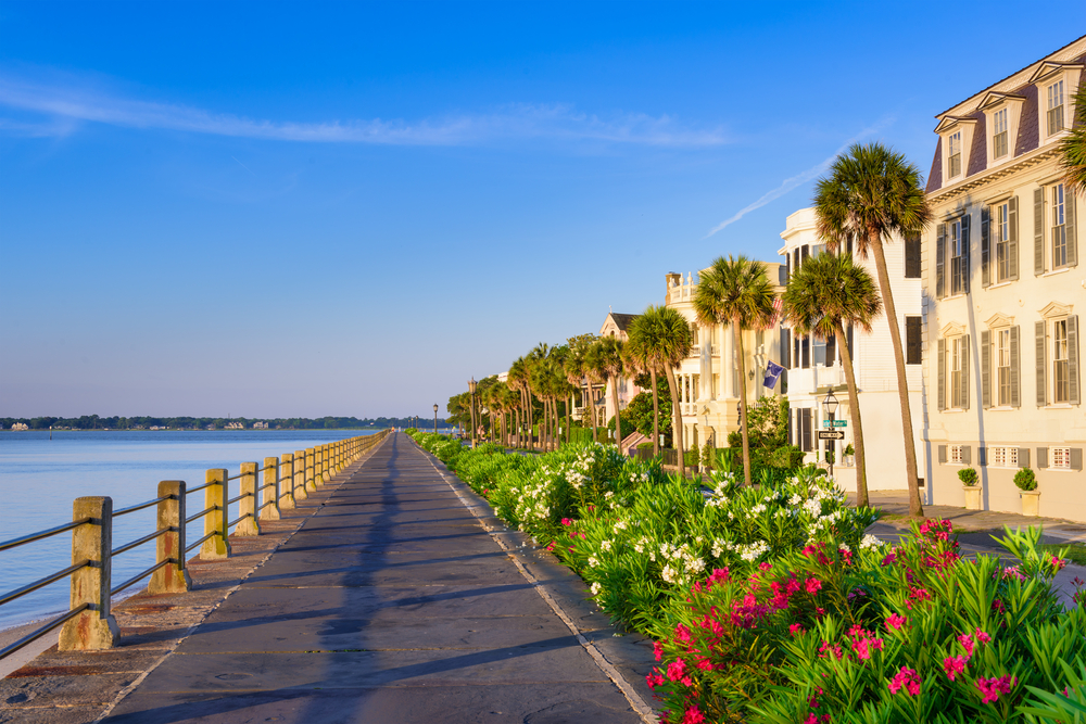 Historical mansions line the dam where the ocean meets the city during the best time to go to South Carolina