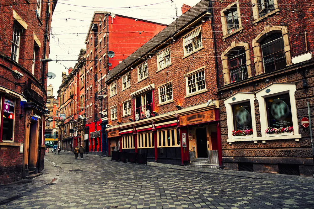 Old red brick buildings on a stone path in Liverpool, one of the best places to visit in the UK