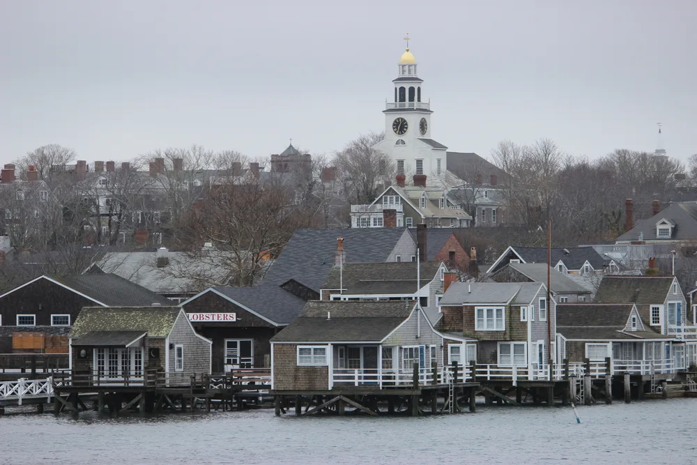 Nantucket harbor with snow on the trees and gloomy sky in the winter, the worst time to visit