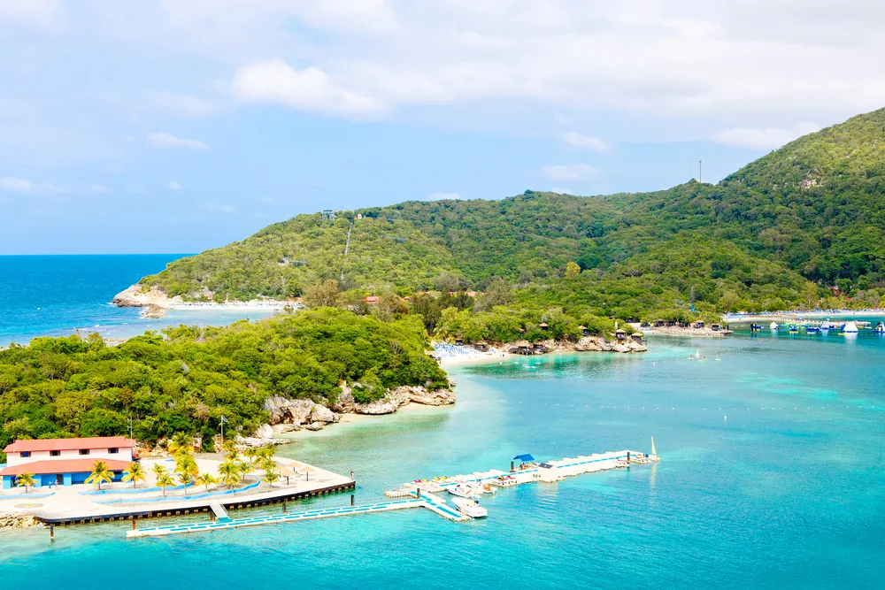 Tropical resort on Labadee Island with teal water and a few boats docked outside of the resort just off the beach