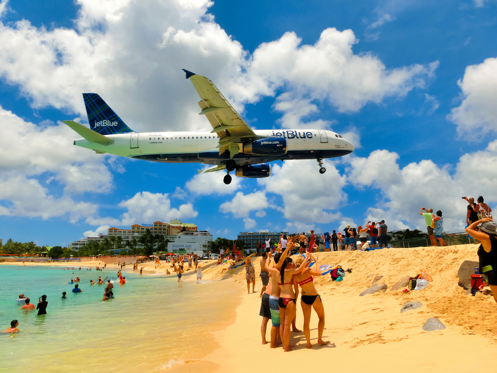 People in Maho Bay pictured watching the planes arrive in Saint Martin during the best time to visit