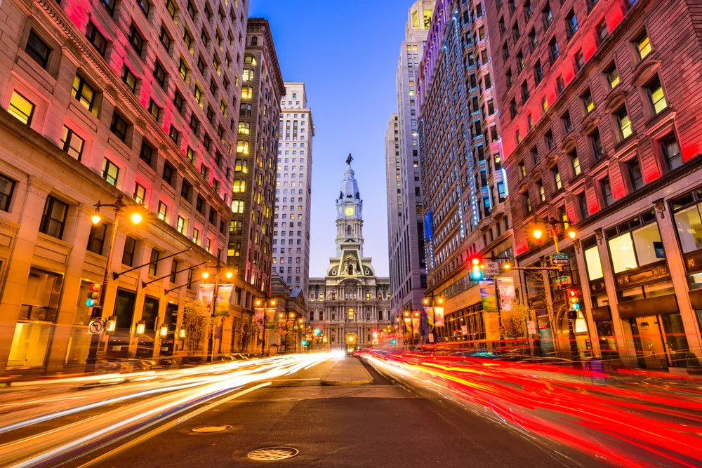 Neat view of Philadelphia's downtown city hall during rush hour in a low-exposure image for a piece on the best places to visit in the United States