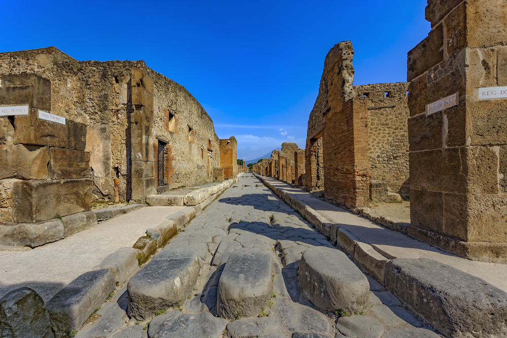 Ruins of Pompeii, as seen from the road with steps where people avoided the dirty sewer water