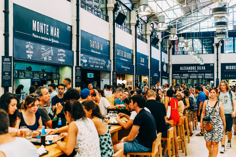 Photo of a food hall packed with tourists in the summer, the overall best time to visit Lisbon