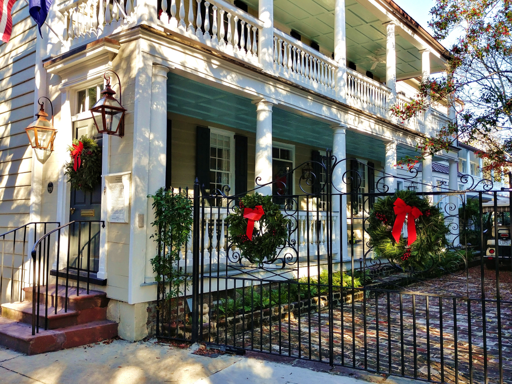 Neat looking wreaths on a big white home in South Carolina, pictured during the winter, the cheapest time to visit