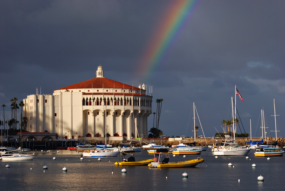 Catalina Island casino with storm clouds overhead and a rainbow ending behind the structure