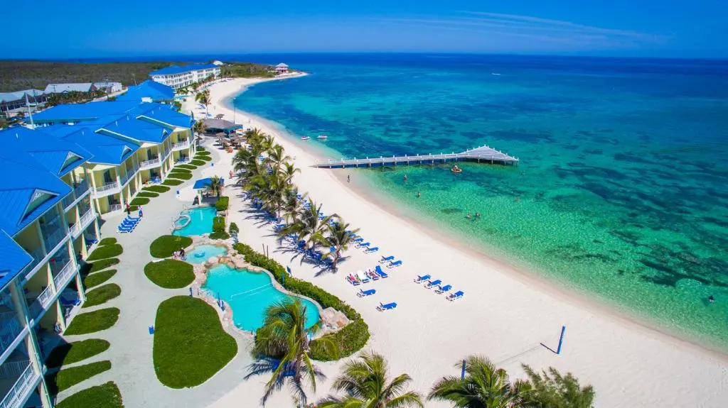 Image of the pool deck and the beach overlooking the water at one of the best all-inclusive resorts in the Caribbean, the Wyndham Reef Resort