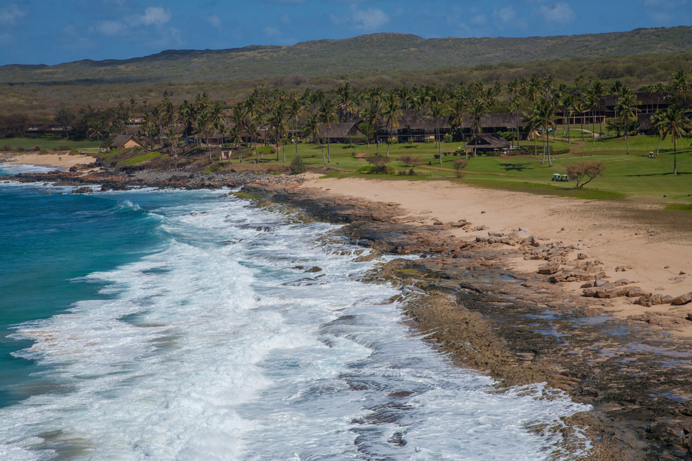 Waves lap the shoreline of Papohaku Beach Park on Molokai, one of the best places to visit on a trip to Hawaii