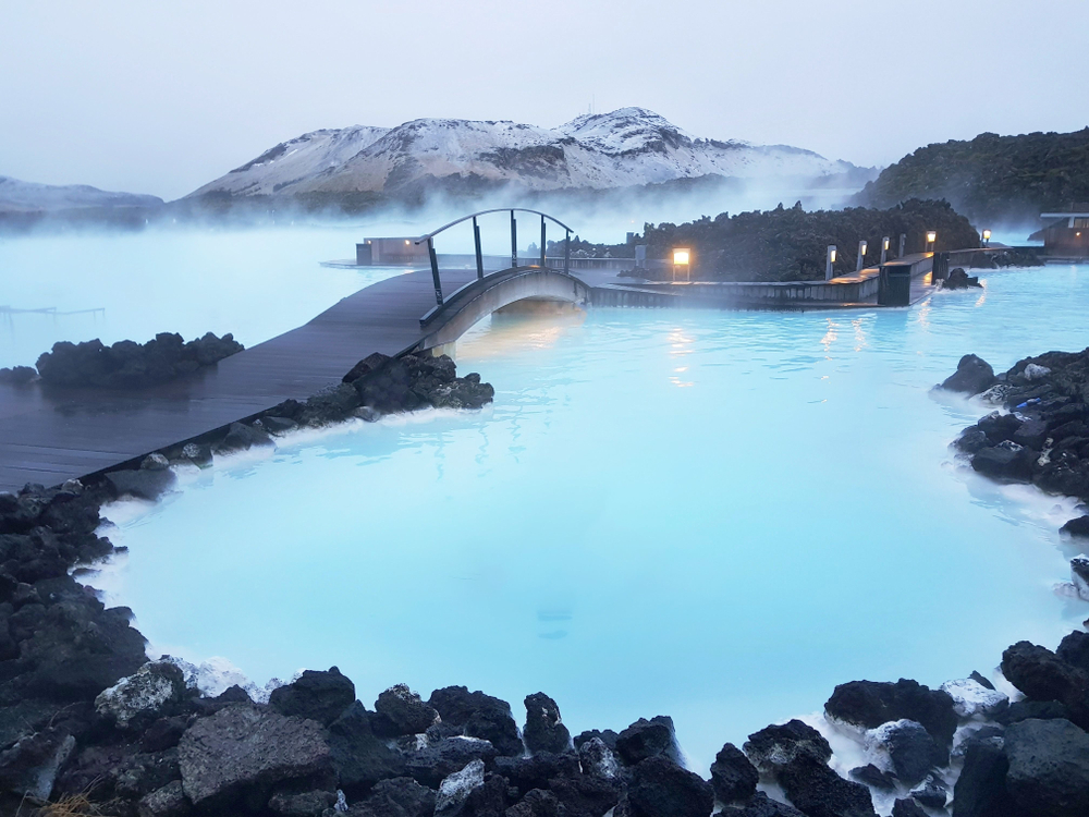Blue Lagoon in Iceland pictured during the least busy time to visit with black rocks all around