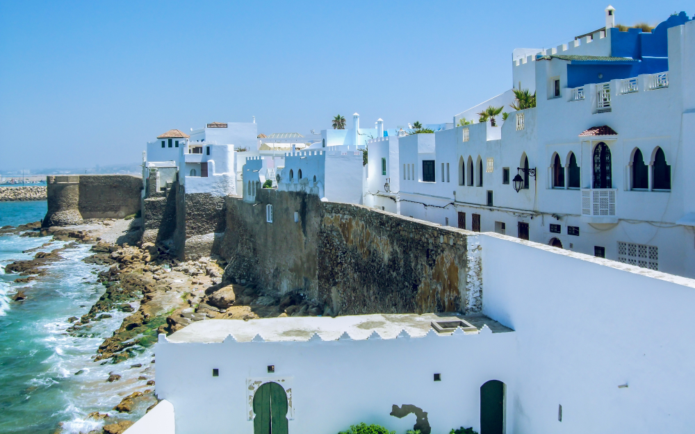 Homes on the seawall overlooking the ocean in Asilah, one of our top picks for must-visit places in Morocco