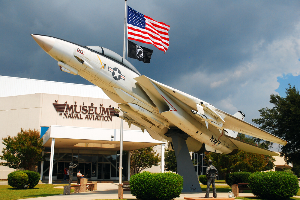 F14 Tomcat on a display stand outside of the Museum of Naval Aviation in Pensacola with cloudy skies overhead