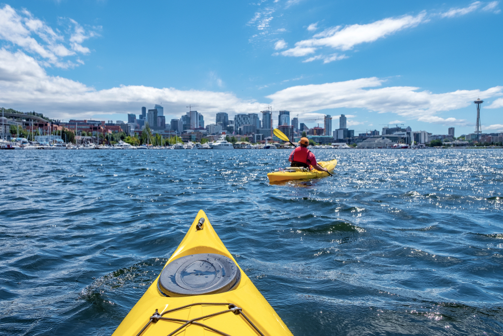 People kayaking on Lake Union in Seattle, one of the best places to visit in July