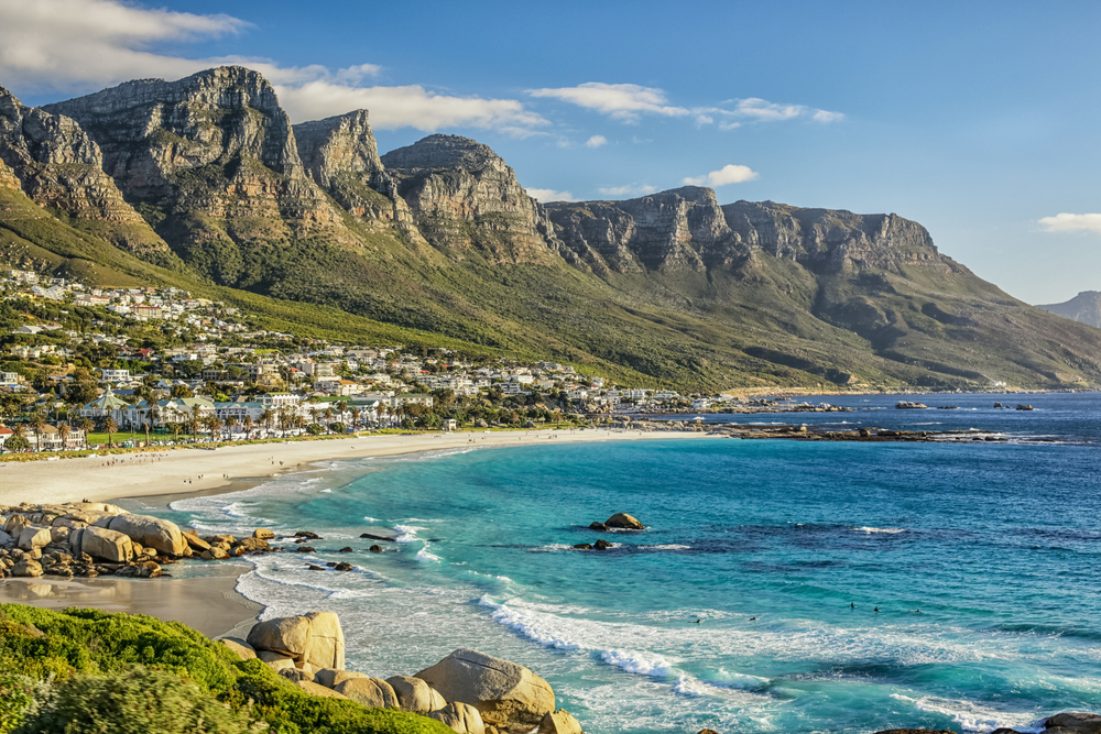 Breathtaking view of the beach and imposing mountains towering over Cape Town, one of the best places to go in March