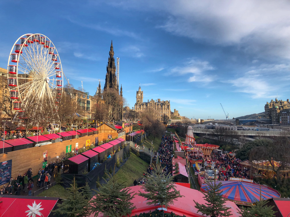 Neat view of the Christmas market in Eidinburgh during the winter with a Ferris wheel on the side of the shops