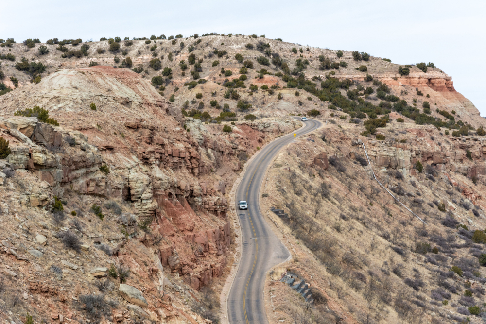 Cars driving on a road going through Palo Duro Canyon during the least busy time to visit