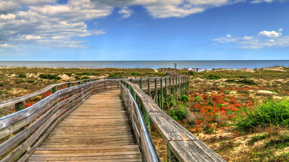 Long wooden pathway leading down to the ocean and the beach in Amelia Island, a top pick for places for couples to visit in Florida