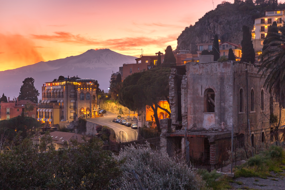 Dusk view of volcanic Mount Etna, as seen from Taormina, one of the best places to visit in Sicily