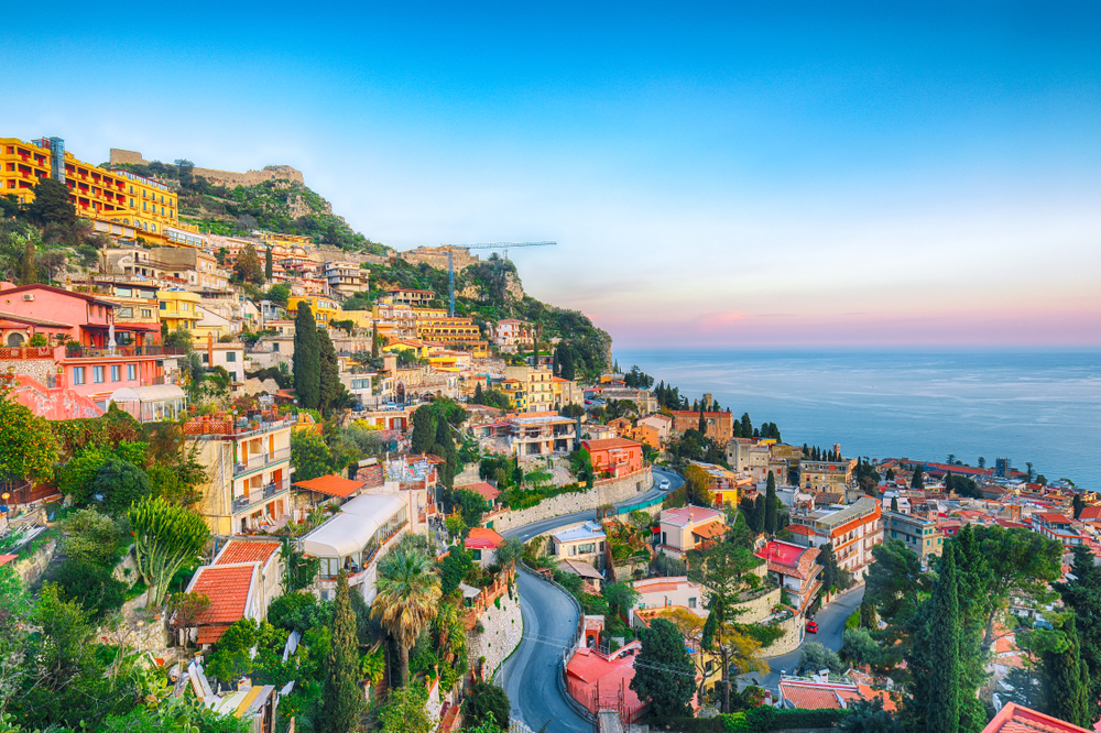 Cliffside city of Tourmina, a top pick for places to see in Sicily, with streets winding through the steep hillside
