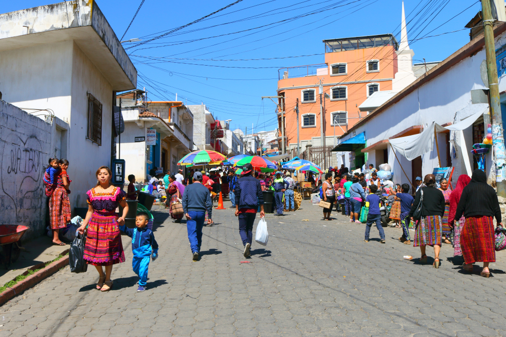 People walking in a market in San Francisco El Alto, one of the best places to visit in Guatemala